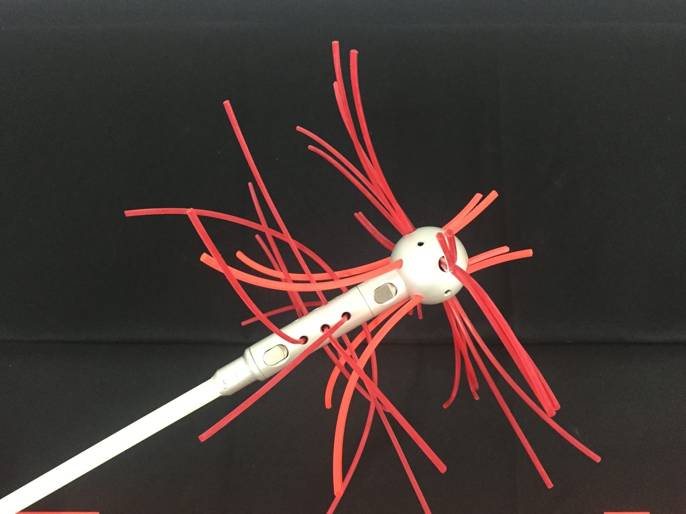 Roterende zweepkop met rode nylon zwepen op een witte veegstok